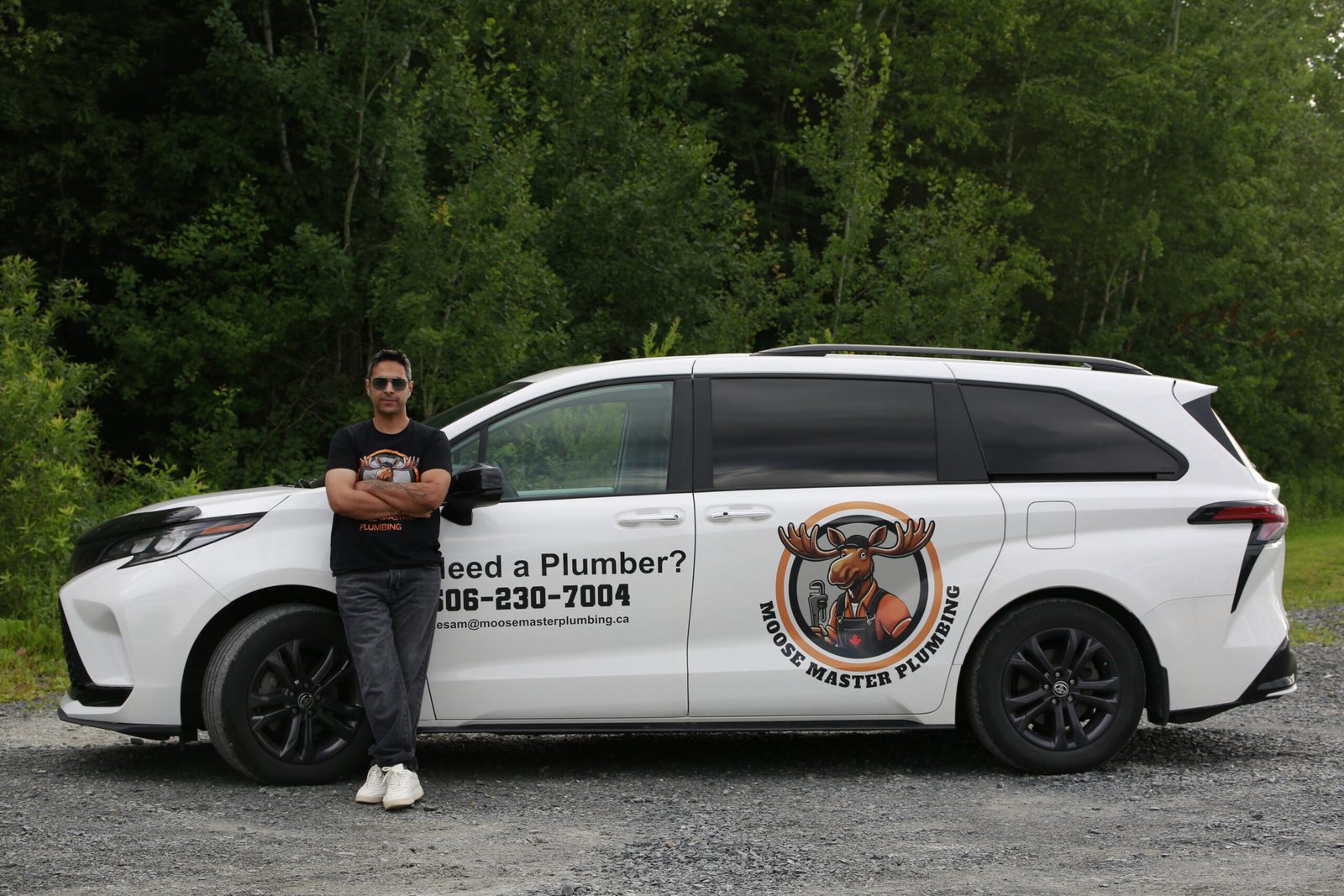 Hesam from Moose Master Plumbing standing beside the company van